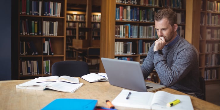 SNU student working on dissertation in the library