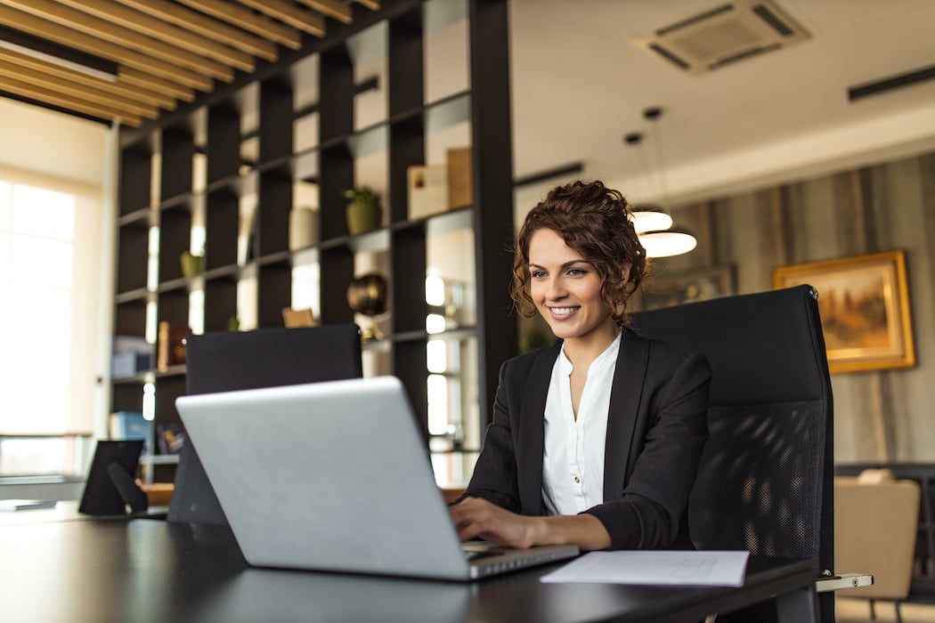 Business woman working on her laptop in an office