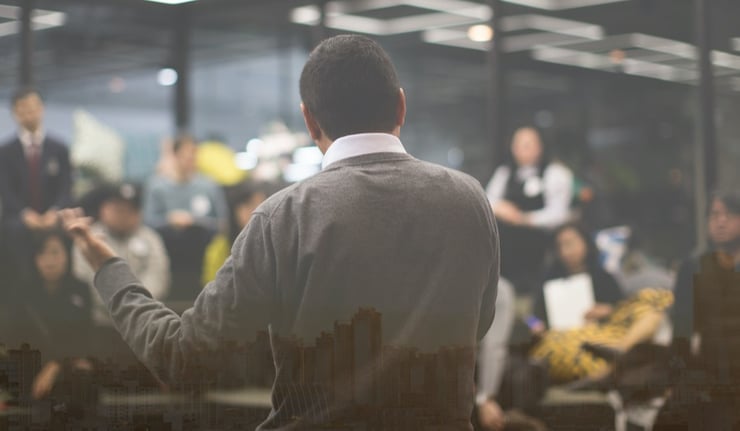  Presenter Giving Talk to People. City Landscape Exposure. 