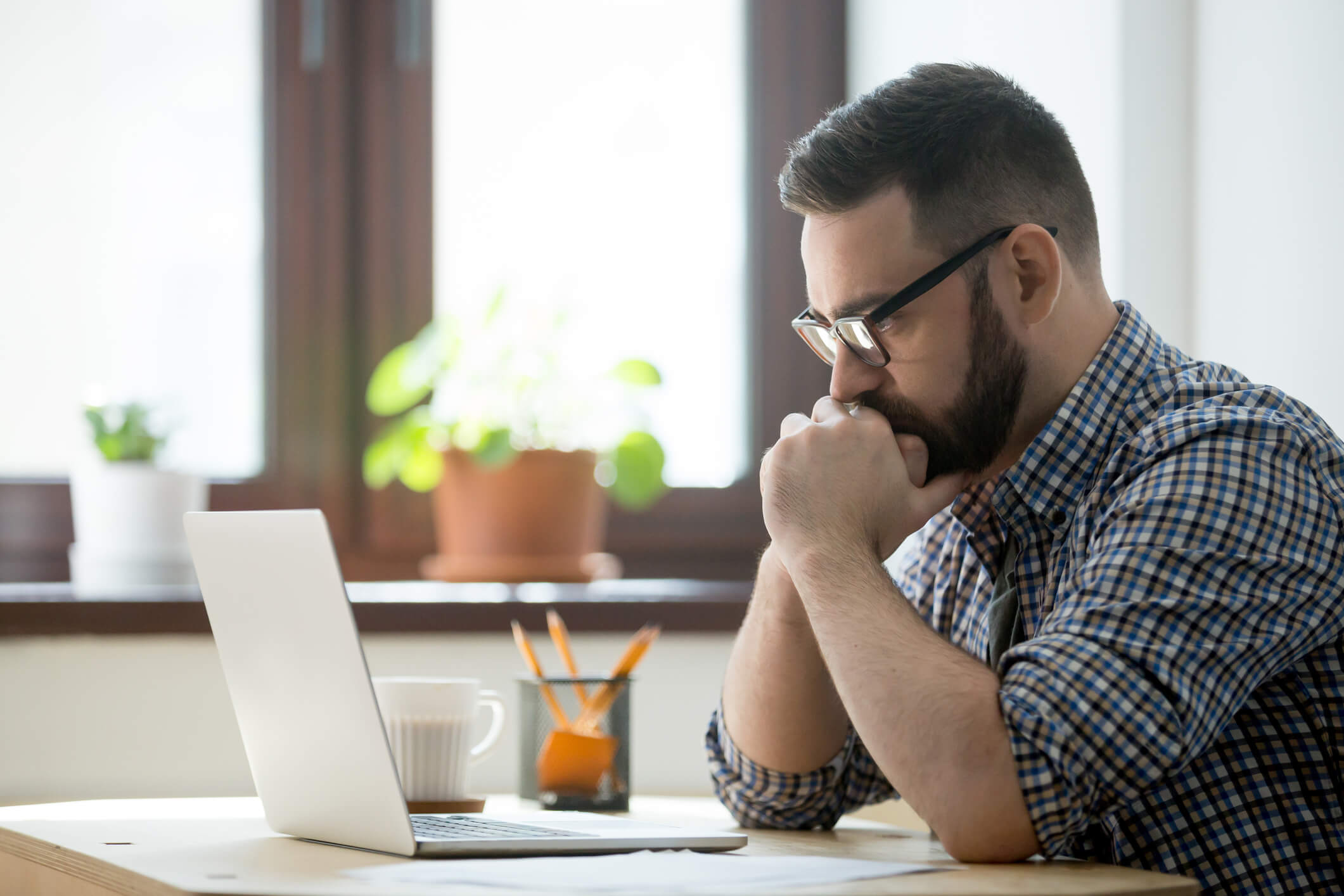 Adult student analyzing a homework on his laptop