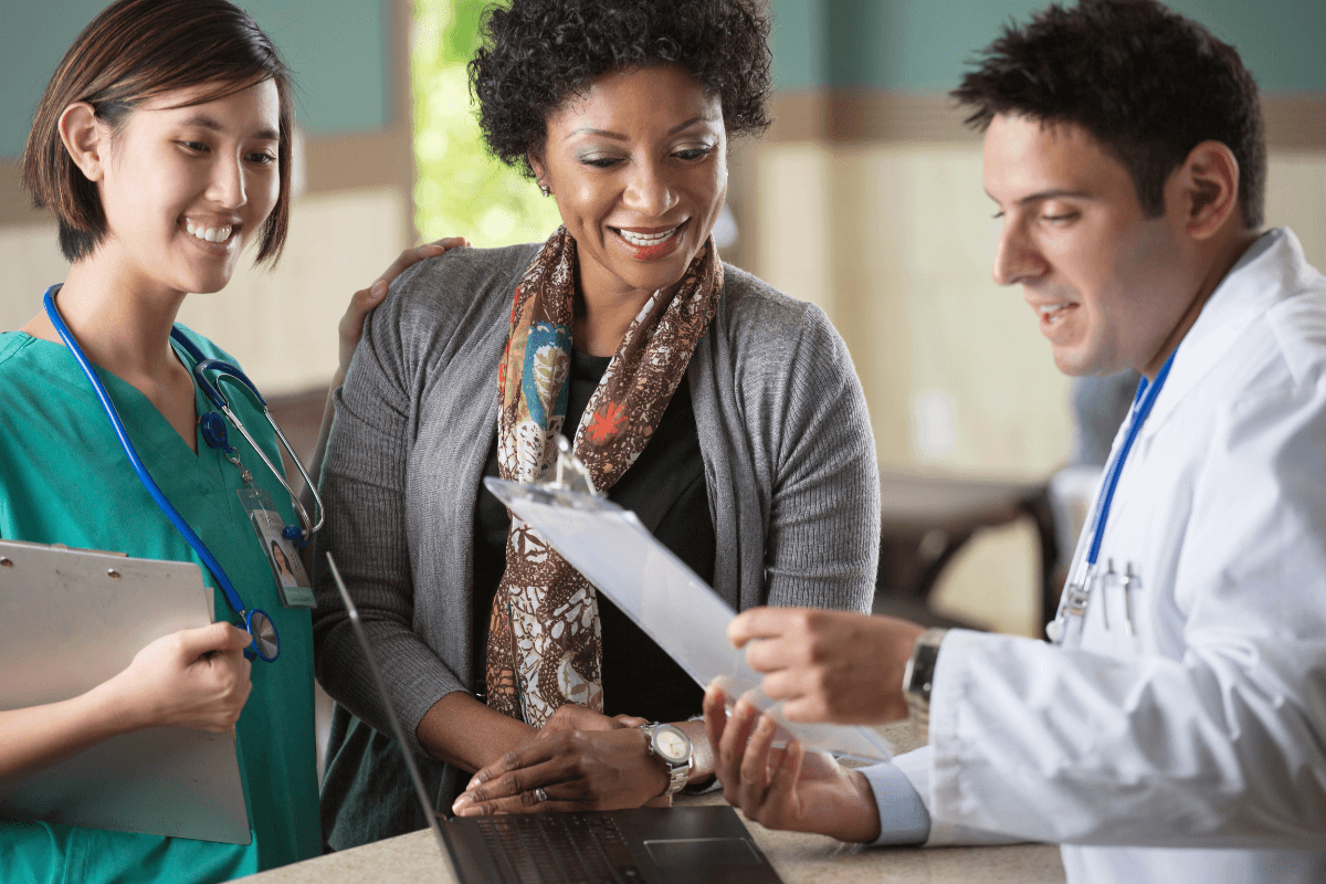 Healthcare Administrator - woman and nurse talking to a doctor