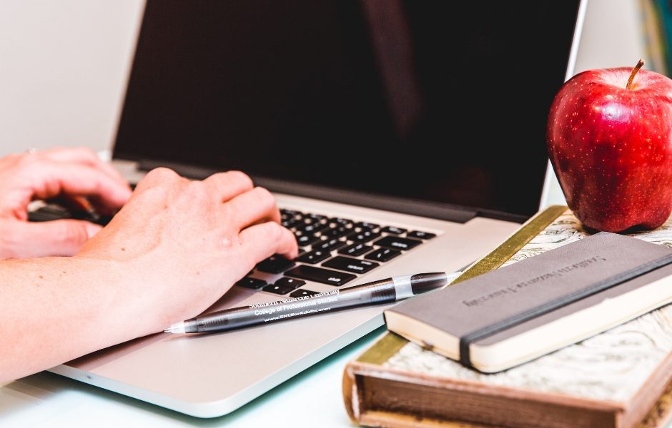 hands typing on laptop computer