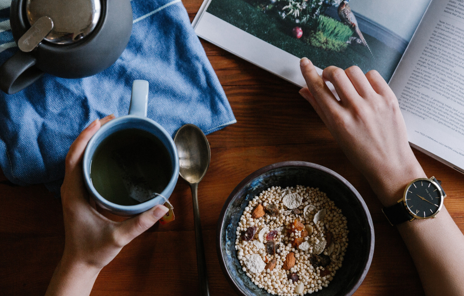 bowl of cereal and cup of coffee by laptop