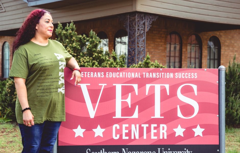 Army Veteran standing beside SNU VETS Center sign