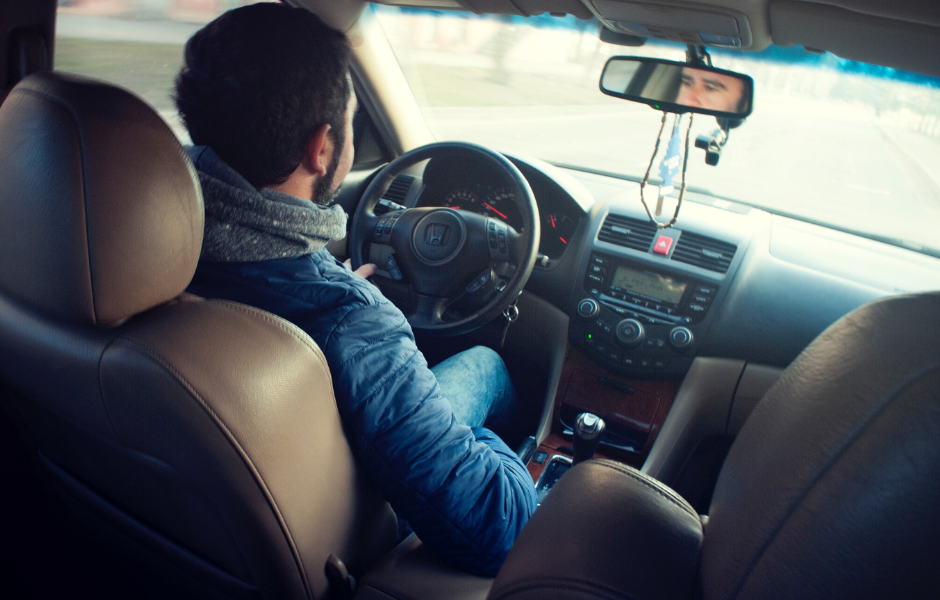 man driving car