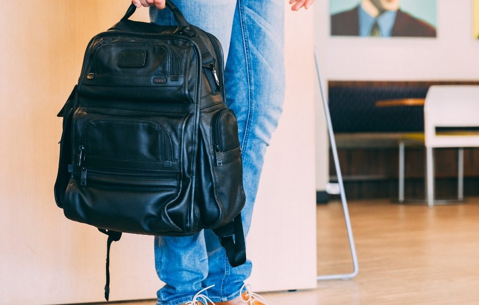 adult standing with backpack