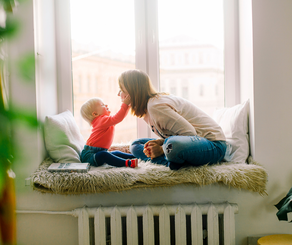 child and woman sitting on bench