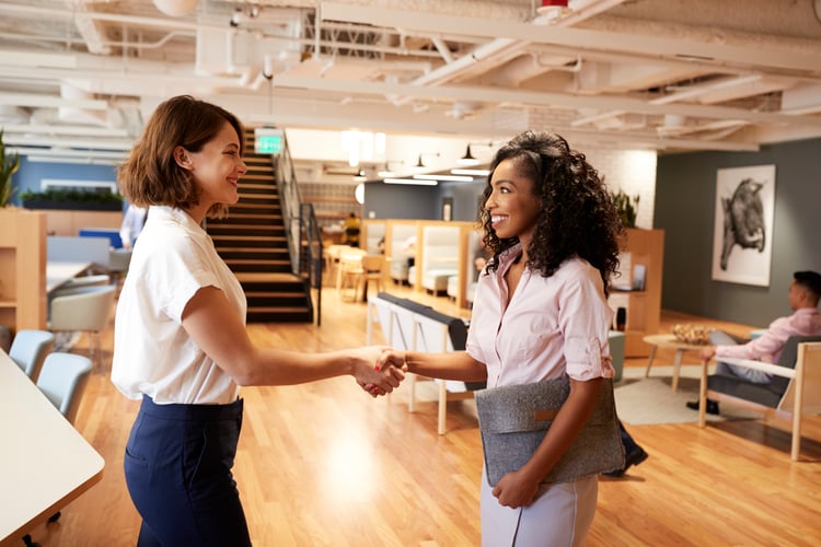 Two managers shaking hands in an office 