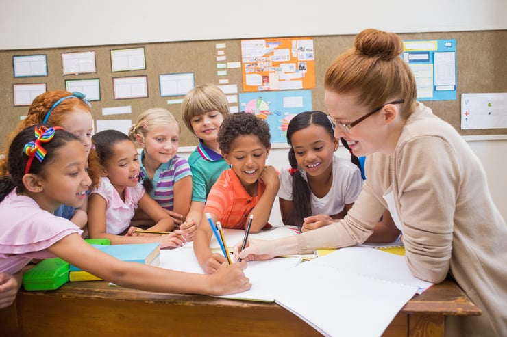 A teacher collaborating with her students.