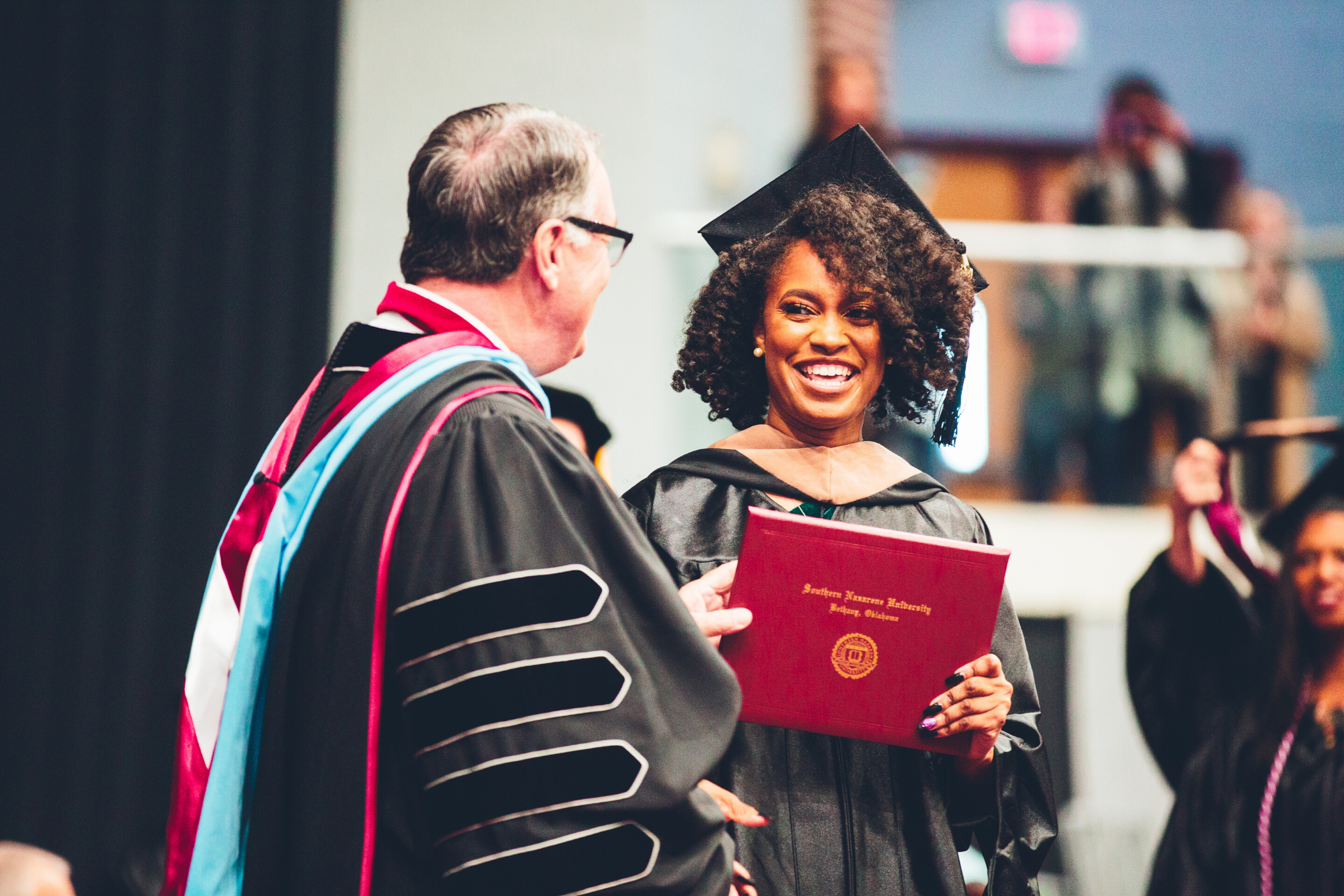 Woman Getting Diploma at Graduation