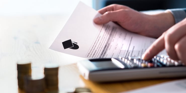 man counting student loans and income with paper and calculator