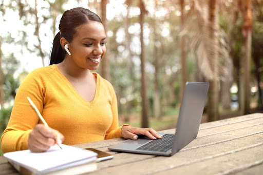 A person researching management degrees on a computer